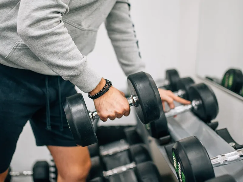 Weight training with dumbbells at the gym
